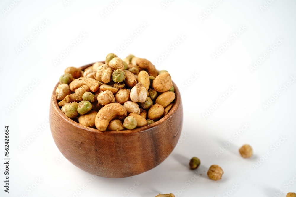 Cocktail nuts mix served in a wooden bowl, selective focus Cocktail nuts mix served in a wooden bowl, selective focus