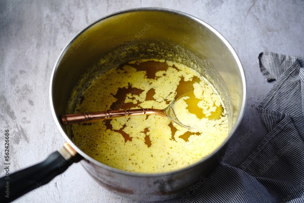 Cooking process of ghee | How to make clarified butter at home, selective focus Cooking process of ghee | How to make clarified butter at home, selective focus