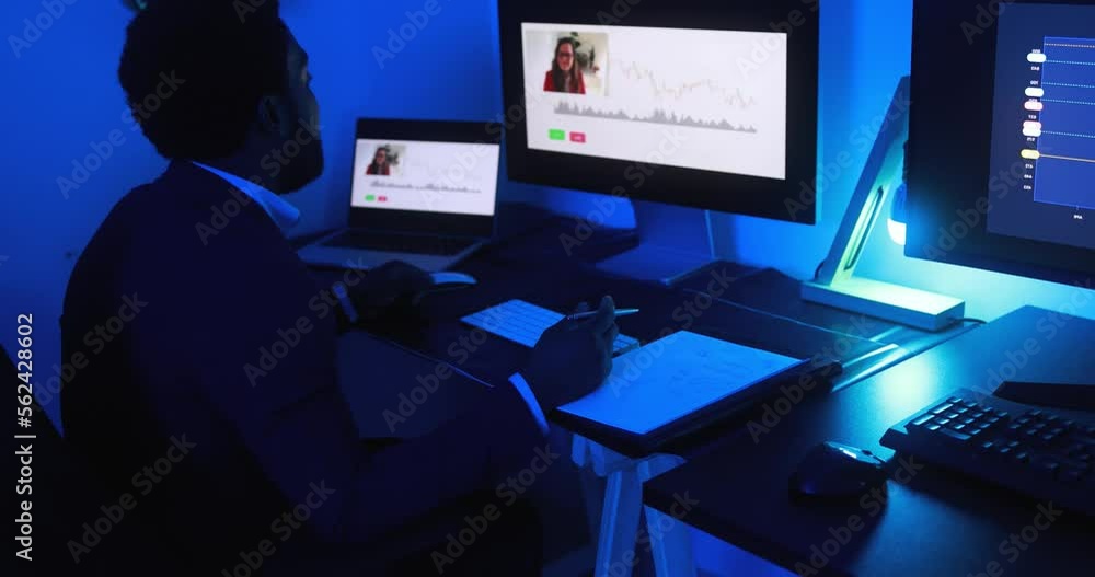African trader doing video call while making forex trading analysis - Online meeting and finance concept African trader doing video call while making forex trading analysis - Online meeting and finance concept