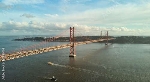 Aerial view of 25th April Bridge in Lisbon, Portugal. Famous landmark on river Tagus. High quality photo