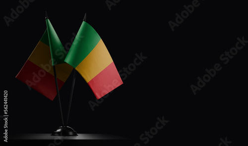 Small national flags of the Mali on a black background