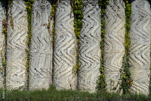 Artful wall made of congrete columns outside