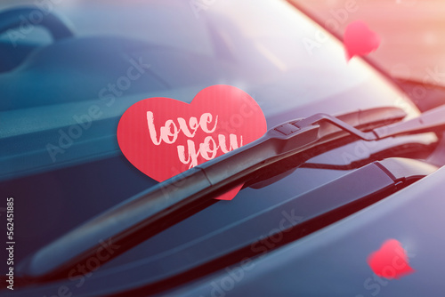 Red heart with text I love you. Paper heart on the windshield of the car under the brush. The concept of a declaration of love or holiday Valentine's Day. Close-up