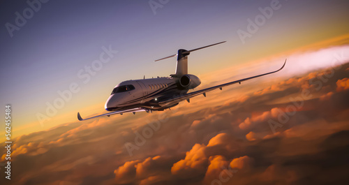 A luxury private jet overflying cloudy skies at sunset photo