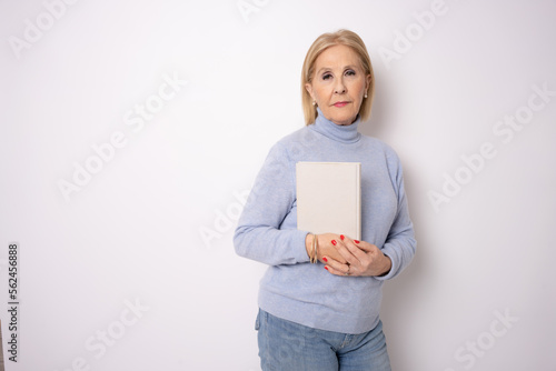 Senior woman reading a book isolated on white background