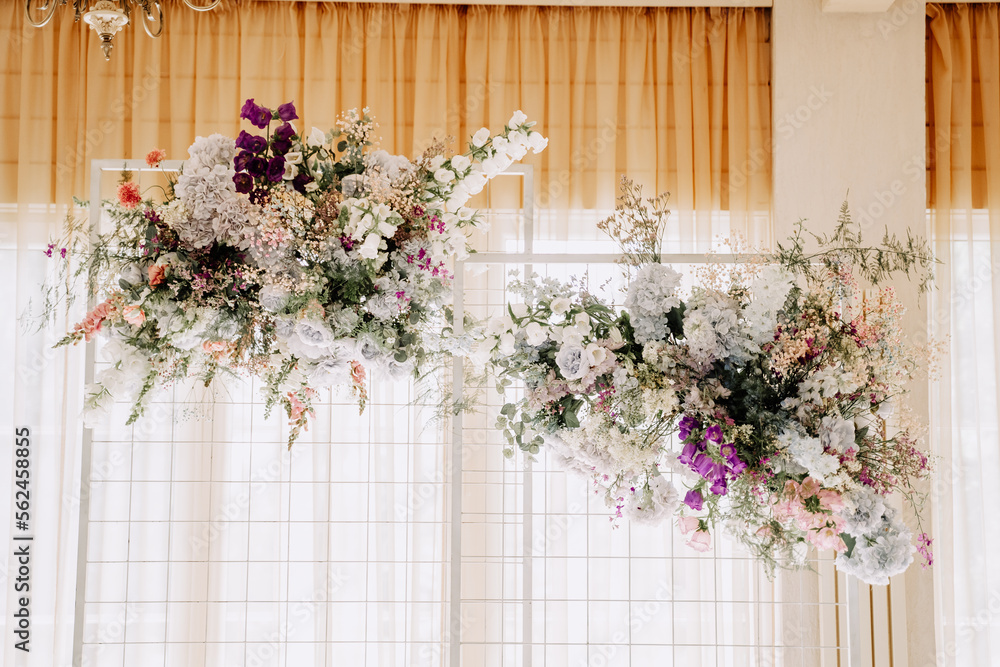 Fototapeta premium Flower Decoration Hanging from Ceiling Indoor Photography. Attractive Floral Ornament Decorating Restaurant Or Apartment Room. Festival Natural and Elegant Decor of Celebrative Event