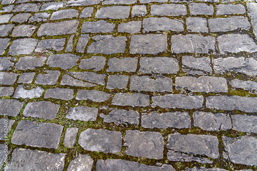 Street with gray paving stone through the historical town