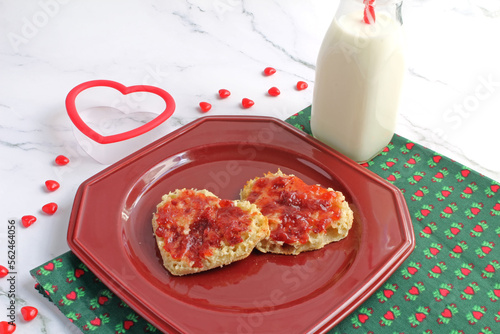 Heart-shaped toasted English muffins with strawberry jam. A treat for the kiddos on Valentine's Day. photo