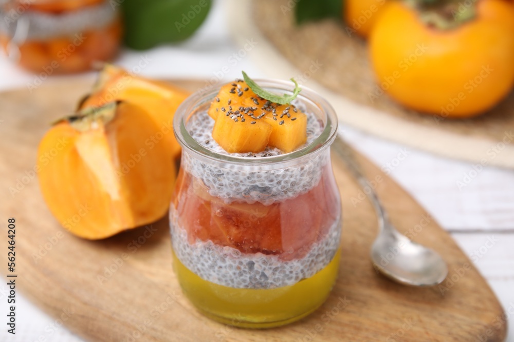 Delicious dessert with persimmon and chia seeds on table