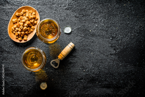 Beer in glasses and crumbs on a plate.