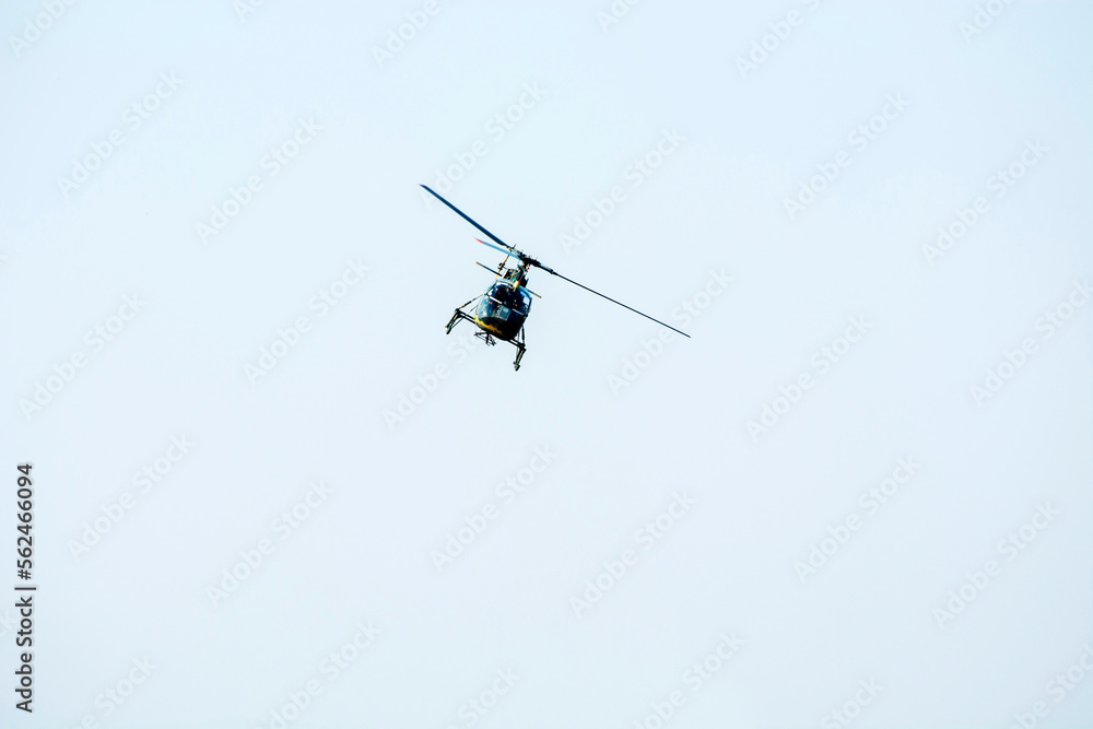 Combat Helicopter is going to attack enemy. Helicopter is flying on isolated blue sky Combat Helicopter is going to attack enemy. Helicopter is flying on isolated blue sky