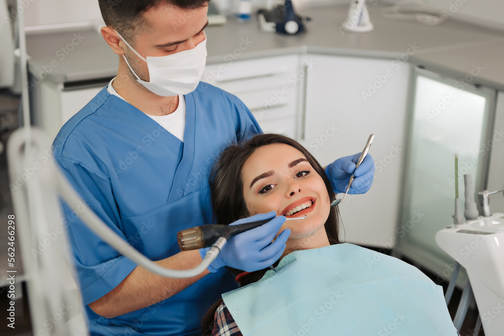 Image of smiling patient looking at camera at the dentist.