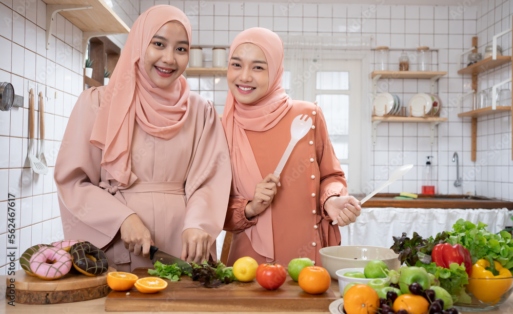 Women Muslim Friends Chef Cook a Healthy organics vegetable foods Cooking Concept. Women Muslim Friends Chef Cook a Healthy organics vegetable foods Cooking Concept.