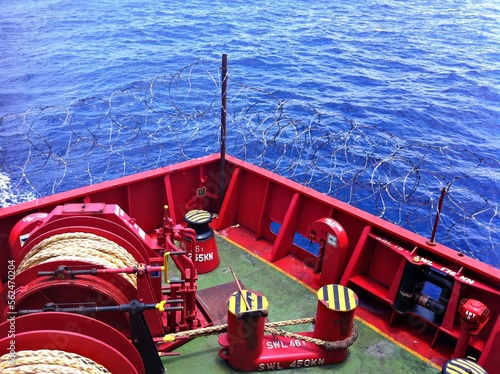 Barbed wire is twisted on board the tanker to protect against pirate attacks when sailing in dangerous areas of the seas and oceans