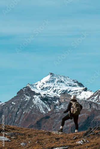 woman overlooking tall mountains in the swiss alps