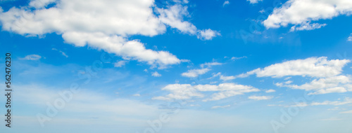 Blue sky and cumulus clouds. Wide photo.