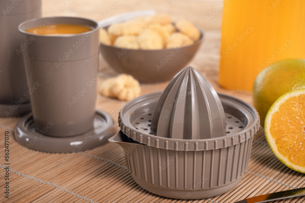 Breakfast table with juice. Colorful cups and plates Breakfast table with juice. Colorful cups and plates