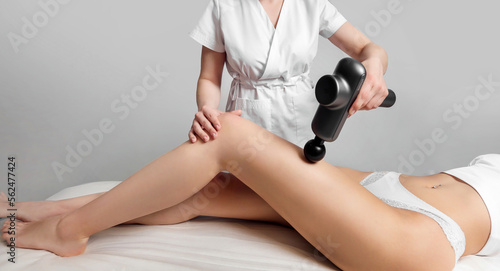 Woman getting anti-cellulite and anti-fat therapy in beauty parlour