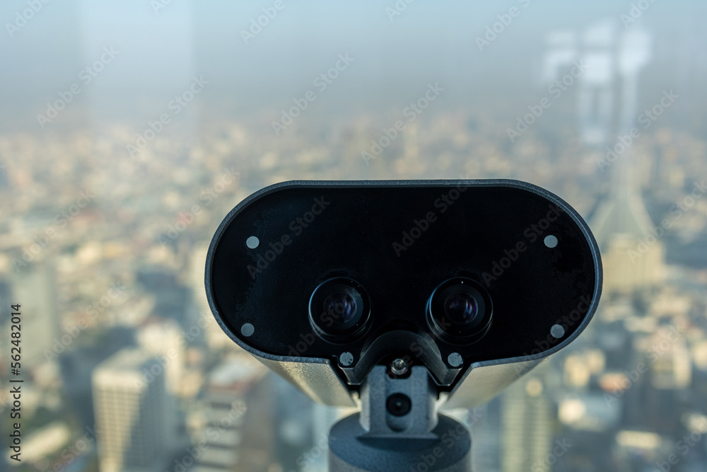 Street binoculars in front of unfocused city. on deck view. Cityscape tourism concept - with copy space Street binoculars in front of unfocused city. on deck view. Cityscape tourism concept - with copy space