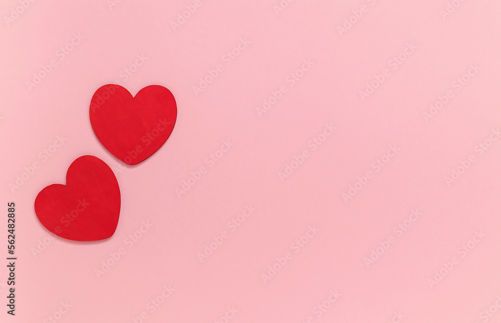 Two wooden hearts on a pink background. Valentines Day concept. Top view. Copy space.