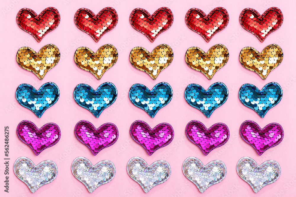 Multicolored hearts on a pink surface. Festive background for Valentine's Day. Love concept. Multicolored hearts on a pink surface. Festive background for Valentine's Day. Love concept.
