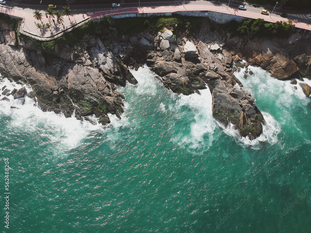 Aerial view of rock in a turquoise ocean