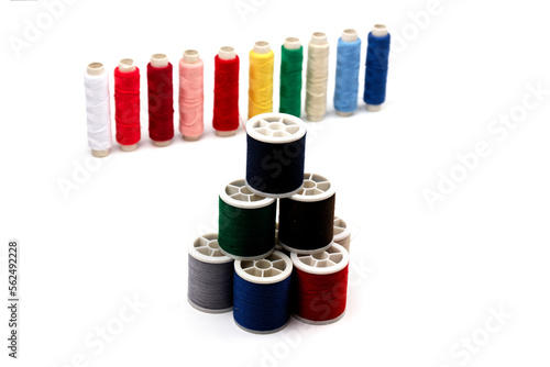 group of sewing spools isolated on white background with real shadows