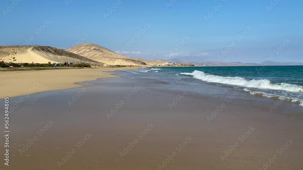 Amazing Cofete beach with endless horizon. Volcanic hills in the background and Atlantic Ocean. Cofete beach, Fuerteventura, Canary Islands, Spain. Playa de Cofete, Fuerteventura, Canary Islands. Amazing Cofete beach with endless horizon. Volcanic hills in the background and Atlantic Ocean. Cofete beach, Fuerteventura, Canary Islands, Spain. Playa de Cofete, Fuerteventura, Canary Islands.