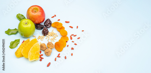 Fototapeta Naklejka Na Ścianę i Meble -  Festive background with fresh fruits, apples, dates, figs, nuts, dried apricots, mango on blue background harvest festival