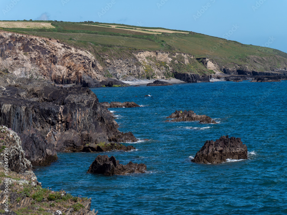 Irish sea landscape. Rocky coast of the Atlantic on a day. The blue sea, mountain beside body of water. Irish sea landscape. Rocky coast of the Atlantic on a day. The blue sea, mountain beside body of water.