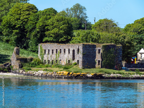 The ruins of an ancient stone grain store on the shore of Clonakilty Bay on a sunny spring day. Irish landscape. The ruins of Arundel Grain Store near Clonakilty.