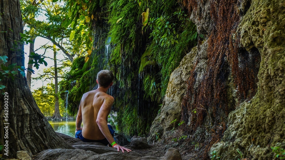 Man at Krause Springs Waterfall near Austin, TX Man at Krause Springs Waterfall near Austin, TX