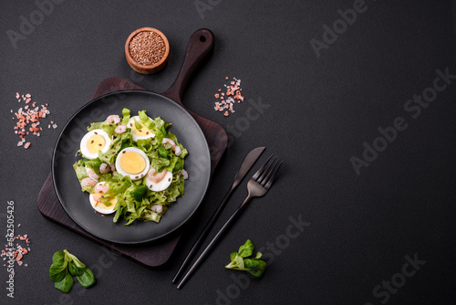 Delicious fresh healthy salad with shrimp, egg, lettuce and flax seeds
