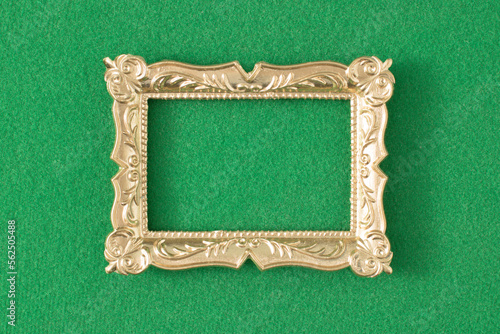 Gold vintage frame on green background. Minimal border composition. photo