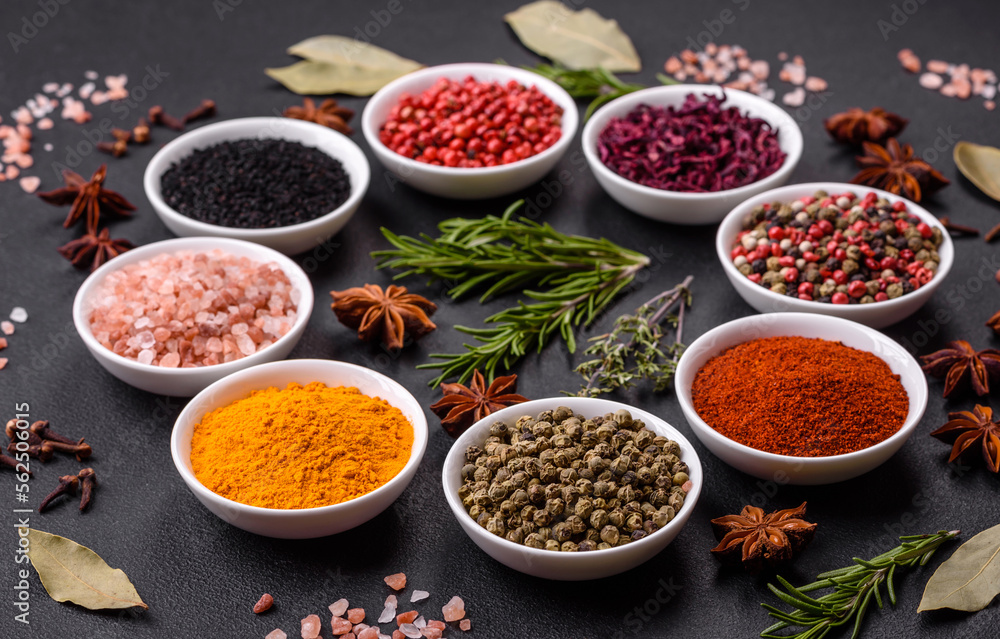 Composition consisting of a variation of several types of spices in white bowls