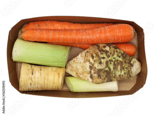 top view of soup vegetables in cardboard bowl, celery root, carrots, leek and parsnips isolated on white background photo