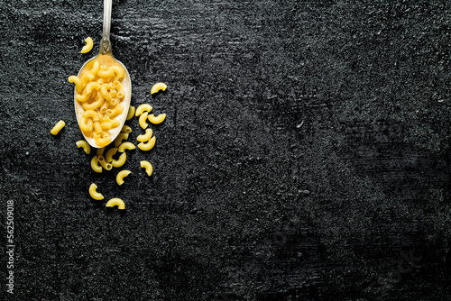 Dry pasta in a spoon.