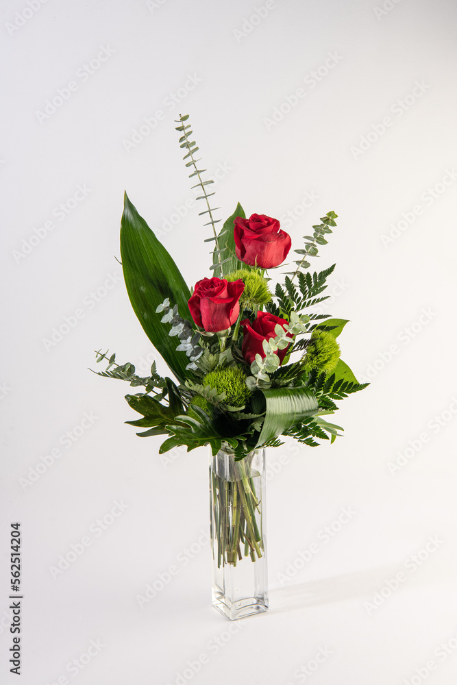Red roses bouquet in a tall glass vase