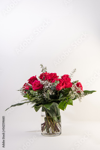 Red roses bouquet in a glass vase in white background