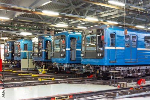 Passenger head locomotives train subway cars are lined up in a row at the repair maintenance in the railway depot.