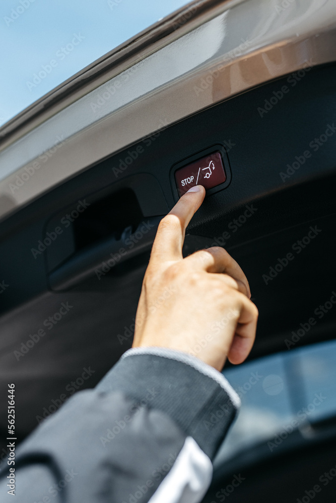 man presses the trunk button to close it close-up man presses the trunk button to close it close-up