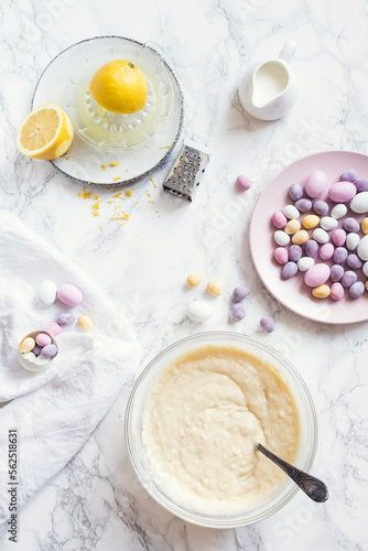 Process of preparation glazed Easter cupcakes decorated with mini chocolate eggs candy