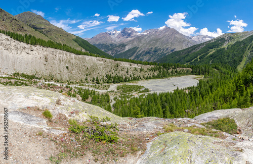 The glacial watercourse an morain under the Dom massif and peaks Lagginhron and Weissmies - Schwitzerland. photo