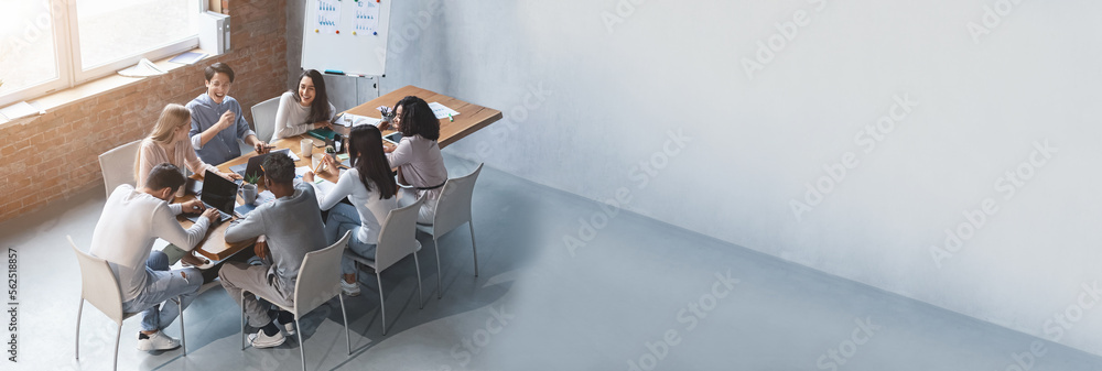 © Prostock-studio - Wide Horizontal Banner With Multiethnic Business Team Discussing New Project In Office