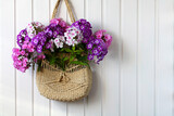 pink, white and violet phlox in a wicker summer bag. naturalness, environmental friendliness.