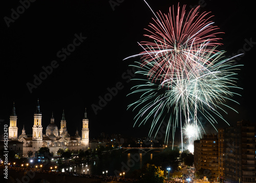 Firework with cityscape night light view of river side Zaragoza skyline