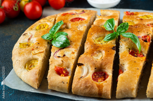 Homemade Italian Focaccia with basil and tomatoes. Italian food. Italian bread