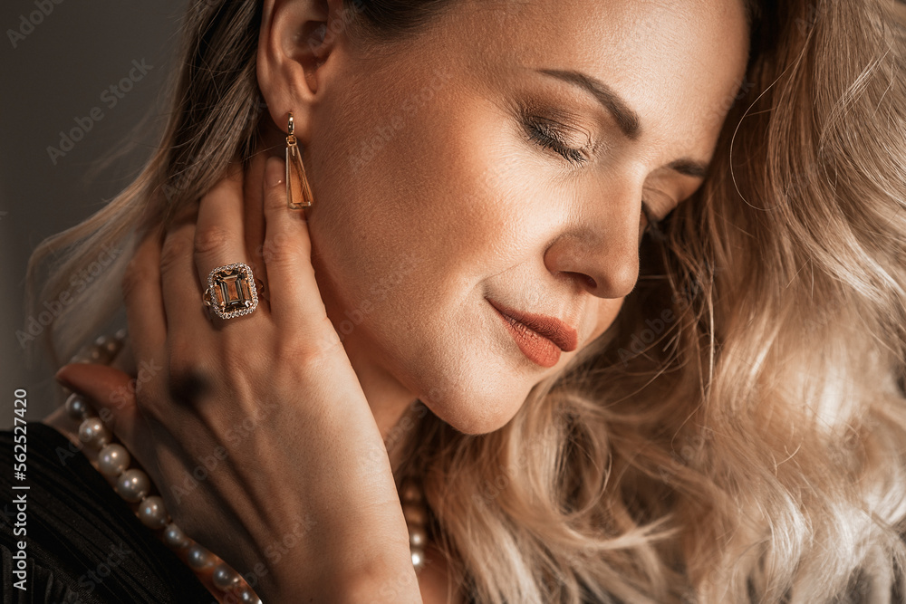 Obraz premium Romantic portrait of a girl dressed in an elegant dress and expensive jewelry