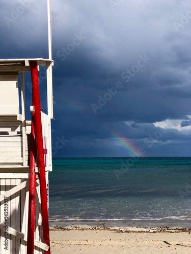lifeguard tower on the beach with rainbow