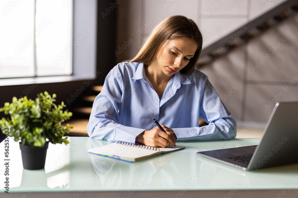 Young businesswoman entrepreneur working on laptop from home office space Young businesswoman entrepreneur working on laptop from home office space